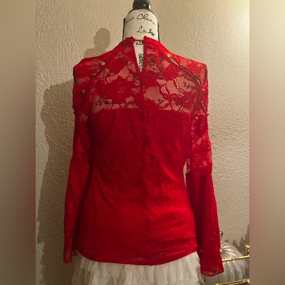 Bracelet-length bell sleeves top with lace and peek-a boo shoulders. - Picture 2 of 5